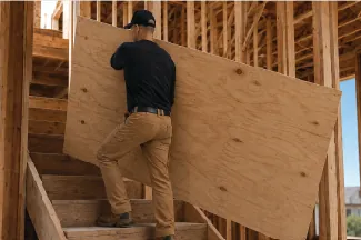 Carrying plywood up a staircase